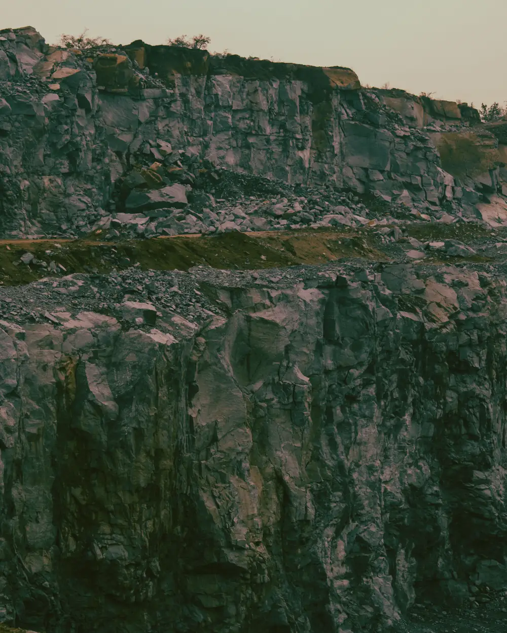 Stepped quarry faces in warm amber dusk light